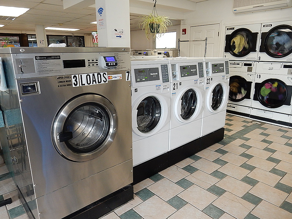 Plenty of washers and dryers to accommodate all sizes of loads with 9 folding tables thru out store